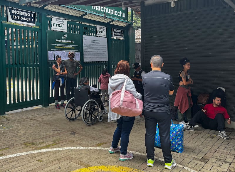 Tourists wait outside the Machu Picchu train station. AFP