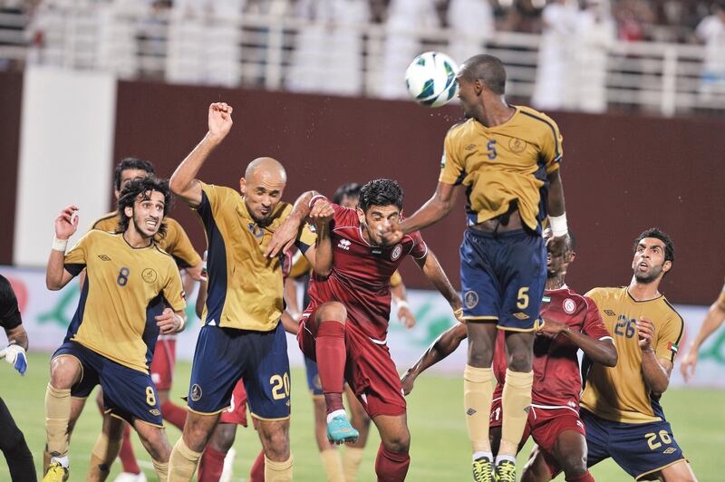 Dubai and Al Wahda players clash at a corner.  Azeem Shaukat