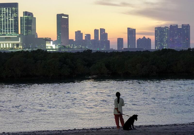 Abu Dhabi, United Arab Emirates, October 17, 2019.  Reem Festival.
-- Standalone:  A woman and her dog enjoy the sunset at Al Reem Island.
Victor Besa/The National
Section:  NA
Reporter:  Panna Munyal