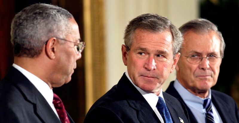 President George W Bush looks toward US Secretary of State Colin Powell as Secretary of Defence Donald Rumsfeld in 2003. Reuters
