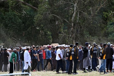 Mourners carry coffins of the Christchurch mosques massacre victims at Memorial Park Cemetery during the funeral ceremony in Christchurch on March 20, 2019. As the first bodies of the Christchurch mosque shooting victims were returned to grieving families, Muslim volunteers from across New Zealand and Australia descended on the small town to help in the burial process. Islamic custom dictates that people have to be buried as soon as possible, but the scale and devastation of March 15's massacre -- that saw 50 killed in the usually quiet southern New Zealand city -- has delayed the handover of bodies to next of kin. / AFP / Anthony WALLACE
