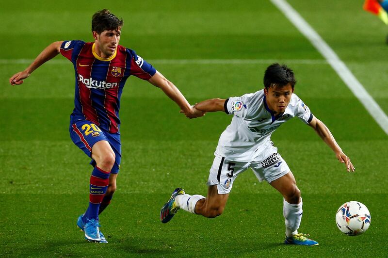 Getafe's midfielder Takefusa Kubo against Sergi Roberto at Camp Nou. EPA