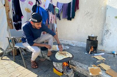 A Palestinian bakes bread in Khan Younis in the southern Gaza Strip on Tuesday. Reuters 