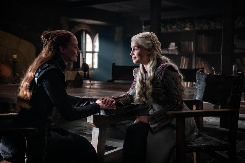 This image released by HBO shows Sophie Turner, left, Emilia Clarke in a scene from "Game of Thrones," that aired Sunday, April 21, 2019. With the Game of Thrones' Jon Snow revealing his royal lineage to his potential rival Daenerys Targaryen, the beleaguered army at Winterfell is about to find out if two chief executives better than one. (Helen Sloan/HBO via AP)
