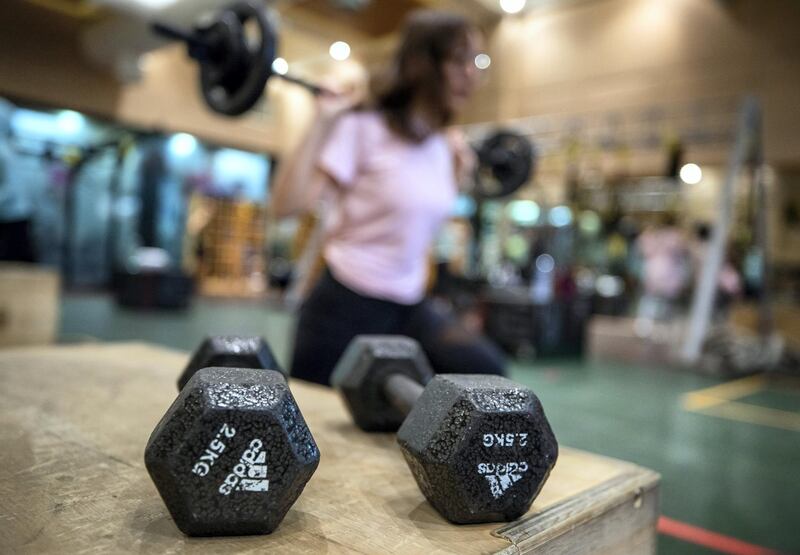 Ihsan Al Sakka does weight training and cardio excercises with his children, Huda, 15 and Nur, 20 at the Abu Dhabi Country Club on June 1st, 2021. Victor Besa / The National.
Reporter: Haneen Dajani for News