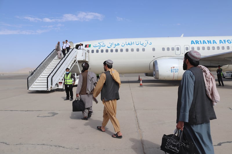 Passengers board a plane as domestic flights resume across Afghanistan, at Ahmad Shah Baba International Airport in Kandahar on September 5, 2021. EPA