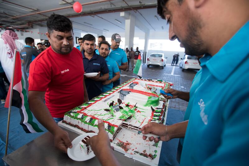 A worker receives a slice of cake.