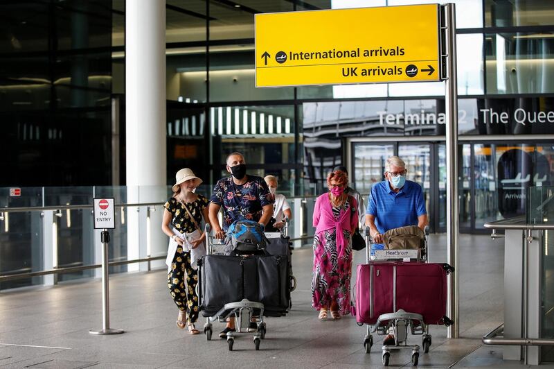 LONDON, ENGLAND - AUGUST 22: Travellers exit Heathrow Airport Terminal 2 on August 22, 2020 in London, England. As of Saturday morning at 4am, travellers arriving in England from Austria, Croatia, and Trinidad and Tobago were required to quarantine themselves for 14 days. At the same time, travellers from Portugal were no longer required to quarantine. (Photo by Hollie Adams/Getty Images)