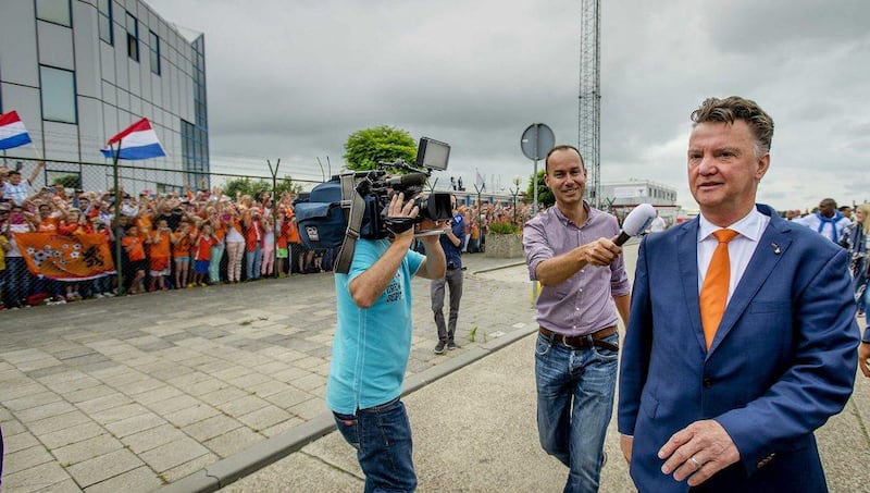 Players of the Dutch national team with coach Louis van Gaal, right, wave to their fans after their arrival at Rotterdam The Hague Airport, Rotterdam, the Netherlands on July 13, 2014. EPA/ROBIN VAN LONKHUIJSEN