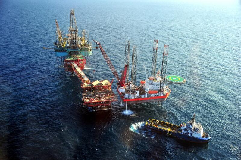 Oil platforms at Abu Dhabi’s offshore NASR Field. Despite low-cost oil, the UAE is well placed because the country has a small deficit and very large cash reserves. Wam
