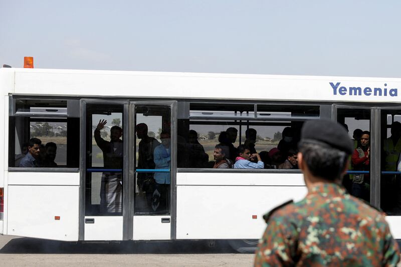 Freed prisoners travel on a bus to an ICRC-chartered plane at Sanaa Airport. Reuters