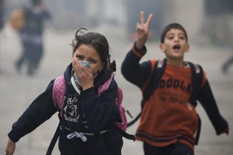 Palestinian children run to take cover during clashes between Palestinian and Israeli soldiers, not seen, in the West Bank city of Hebron, Thursday, Feb. 25, 2010. Palestinians in Hebron continued to protest Thursday over the Israeli decision to recognize a disputed West Bank shrine as one of its national heritage sites. Palestinian President Mahmoud Abbas warned earlier this week that the region could plunge into a "religious war" over the decision. (AP Photo/Bernat Armangue) *** Local Caption ***  JRL107_APTOPIX_Mideast_Israel_Palestinians_.jpg