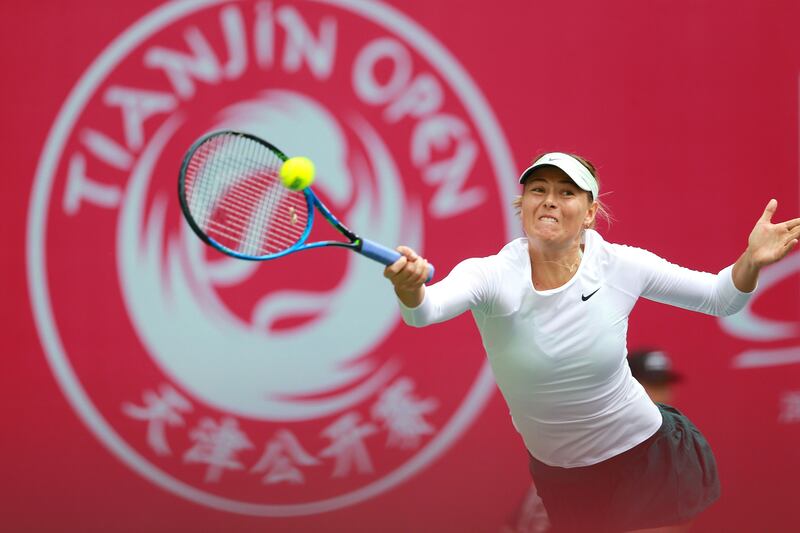Maria Sharapova of Russia hits a return against Irina-Camelia Begu of Romania during their women's singles first round match at the Tianjin Open tennis tournament in Tianjin on October 11, 2017. / AFP PHOTO / STR / China OUT