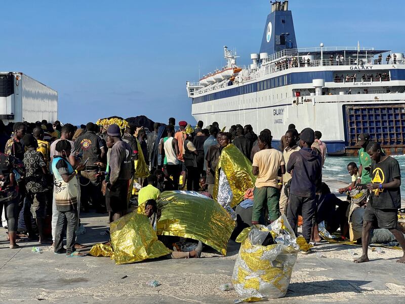 Migrants wait on the island of Lampedusa as Italian authorities prepare to transfer them on September 17. EPA