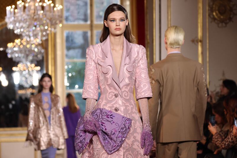 A coat with cut-out collars to match the swirling jacquard material. AFP
