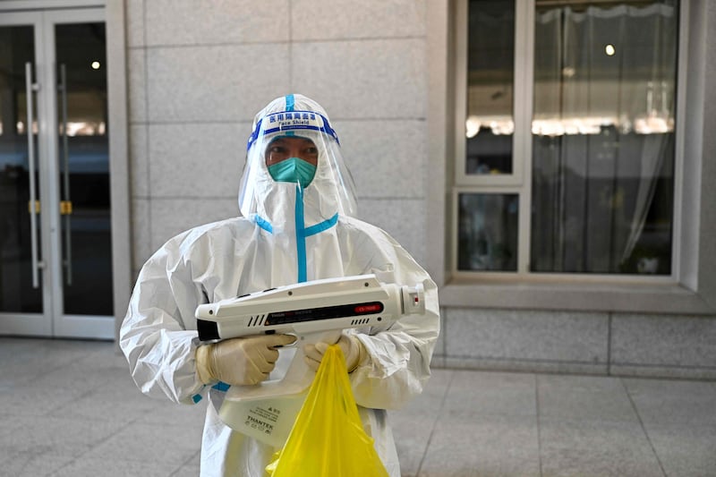 A worker prepares to spray disinfectant in an area within the closed-loop bubble at the Taizicheng train station. AFP