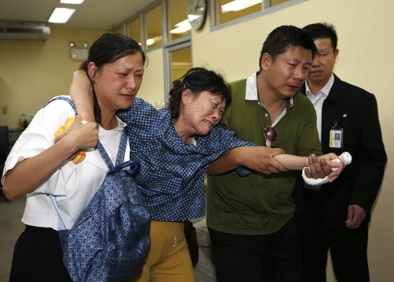 Relatives of a victim from Shanghai cry as families identify and claim the deceased. Thai authorities identified five victims as Thai and four as Chinese — two of them from Hong Kong — along with two Malaysians and one Singaporean, and said the nationalities of the other eight victims remained unknown. Rungroj Yongrit / EPA