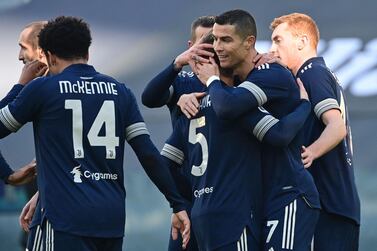 Juventus' Portuguese forward Cristiano Ronaldo (R) embraces Juventus' Brazilian midfielder Arthur after Arthur opened the scoring during the Italian Serie A football match Juventus vs Bologna on January 24, 2021 at the Juventus stadium in Turin. / AFP / MIGUEL MEDINA