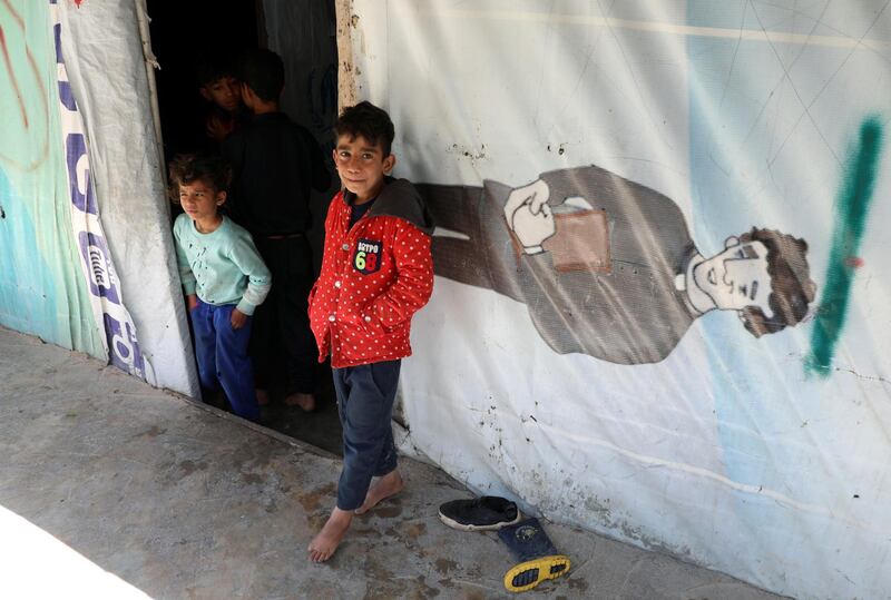 A Syrian refugee stands outside a tent at an informal tented settlement in the Bekaa valley, Lebanon March 12, 2021. Picture taken March 12, 2021. REUTERS/Mohamed Azakir