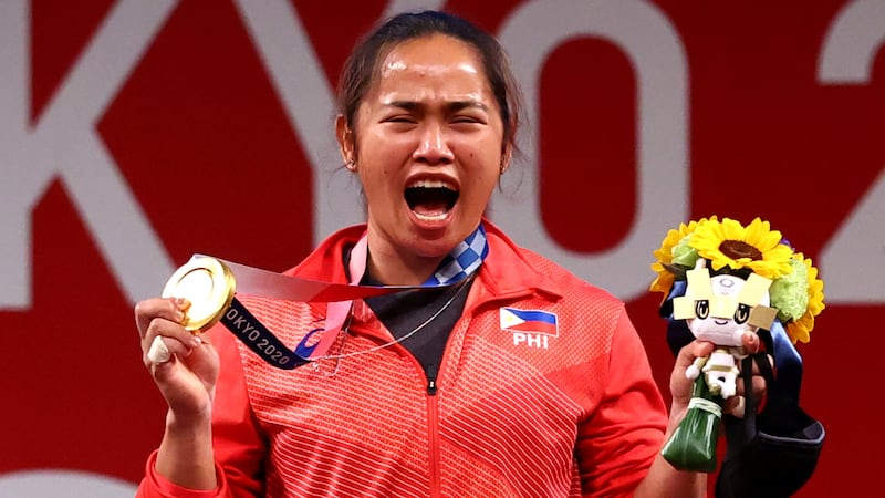 Hidilyn Diaz of the Philippines celebrates after winning gold in the women's 55kg weightlifting event of the Tokyo 2020 Olympic Games at the Tokyo International Forum in Tokyo, Japan.