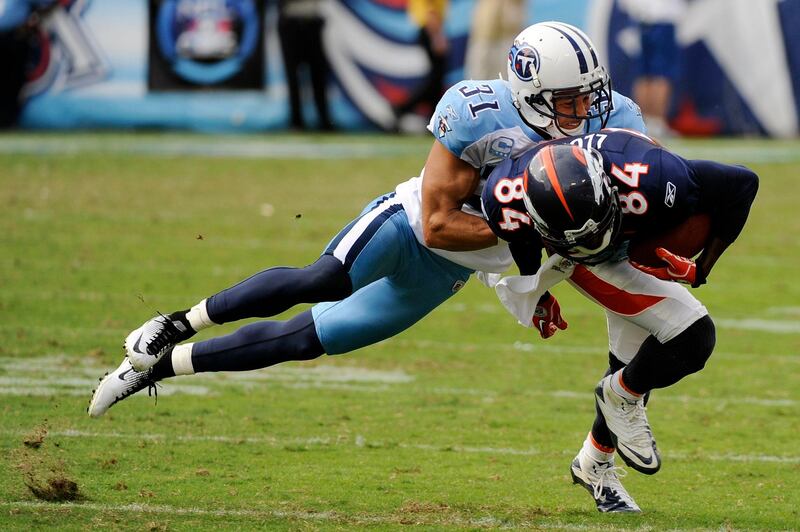 Tennessee Titans cornerback Cortland Finnegan (31) brings down Denver Broncos wide receiver Brandon Lloyd (84) in the fourth quarter of an NFL football game on Sunday, Sept. 25, 2011, in Nashville, Tenn. The Titans won 17-14. (AP Photo/Frederick Breedon) *** Local Caption ***  Broncos Titans Football.JPEG-0c692.jpg