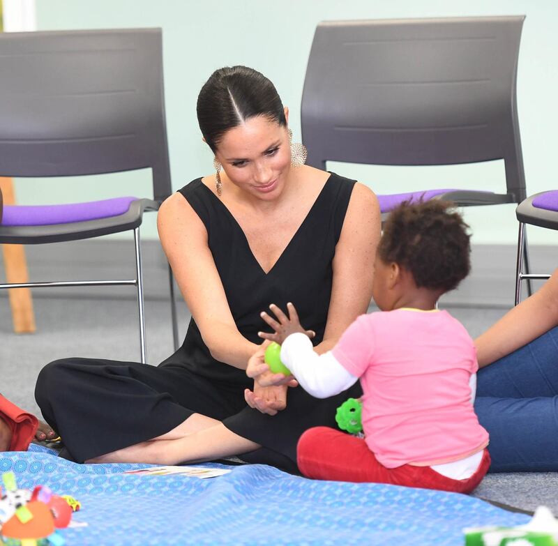 Meghan played with many young attendees as she visited Mothers 2 Mothers. EPA