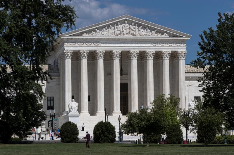 In this June 26, 2017 file photo, The Supreme Court is seen on the last day of its term, in Washington.  The Trump administration is back at the Supreme Court, asking the justices to continue to allow strict enforcement of a temporary ban on refugees from around the world. The Justice Departmentâ€™s high court filing Monday follows an appeals court ruling last week that would allow refugees to enter the United States if a resettlement agency in the U.S. had agreed to take them in.  (AP Photo/J. Scott Applewhite)