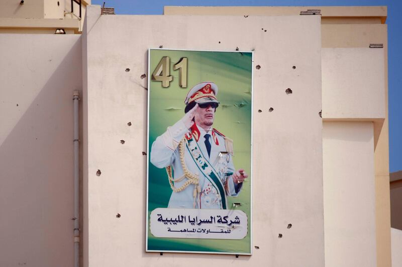 A portrait of Moammar Gadhafi on a wall covers by bullets marks is displayed on a building in the Abu Salim district, in Tripoli, Libya, Friday, Aug. 26, 2011, where rebels had battled Gadhafi's fighters holed up in residential buildings for most of the previous day. (AP Photo/Francois Mori) *** Local Caption ***  Mideast Libya.JPEG-092a6.jpg