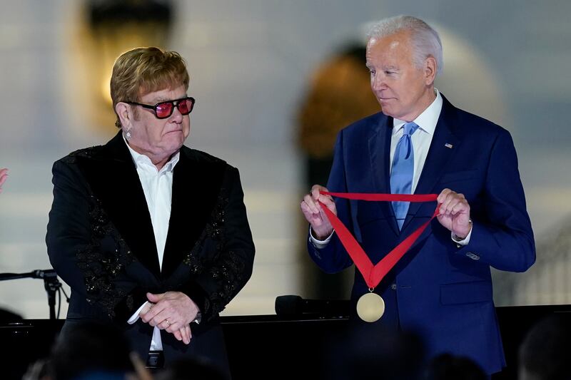 President Joe Biden presents Elton John with the National Humanities Medal after the concert. AP