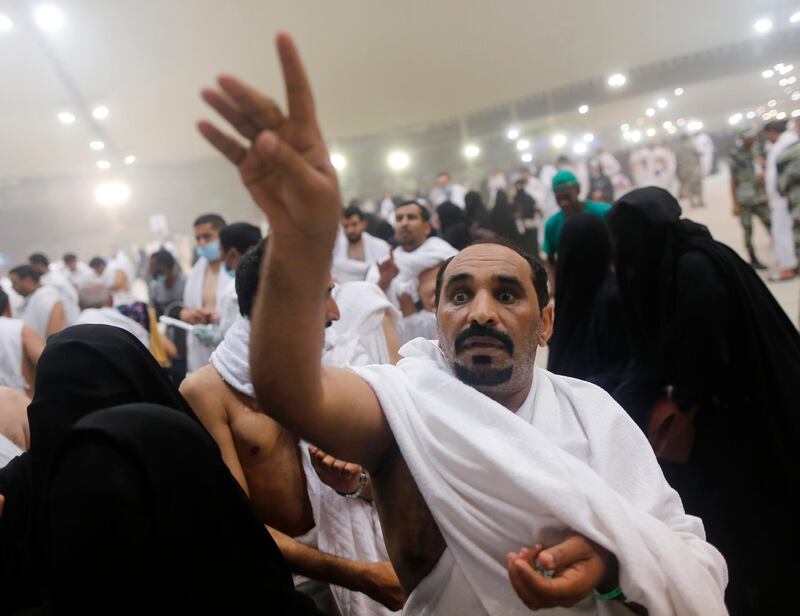 A Muslim pilgrim casts stones at a pillar symbolising the stoning of Satan, in a ritual called "Jamarat," the last rite of the annual Hajj, on the first day of Eid al-Adha, in Mina near the holy city of Makkah, Saudi Arabia.  AP