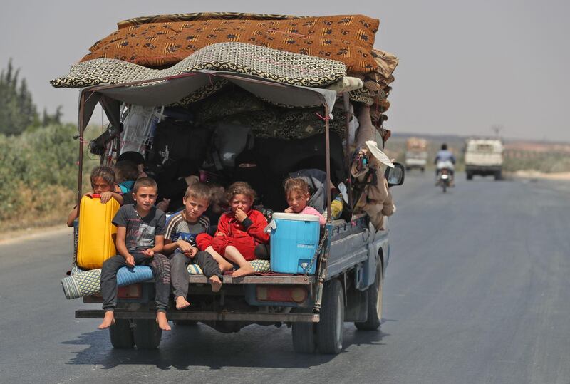 Syrian civilians flee a conflict zone in Syria's rebel-held northwestern region of Idlib, where government bombardment has killed hundreds since late April, near Maar Shurin on the outskirts of Maaret Al Numan. Damascus said it is opening a corridor for civilians to leave the rebel-held northwestern region of Idlib.  AFP