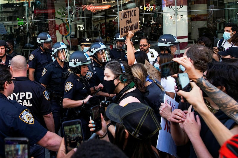 FILE PHOTO: Demonstrators scuffle with NYPD police officers as they try to march trough Times Square during a protest against racial inequality in the aftermath of the death in Minneapolis police custody of George Floyd, in New York City, New York, U.S. June 14, 2020. REUTERS/Eduardo Munoz/File Photo
