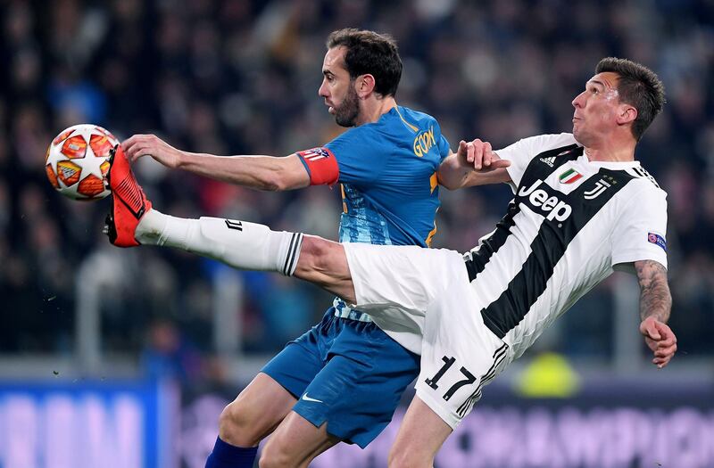 Juventus' Mario Mandzukic in action with Atletico Madrid's Diego Godin. Reuters