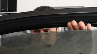 Mohammed Saidur fits window tints. Cheap tinting will not do the same job as a more expensive service, experts say. Chris Whiteoak / The National