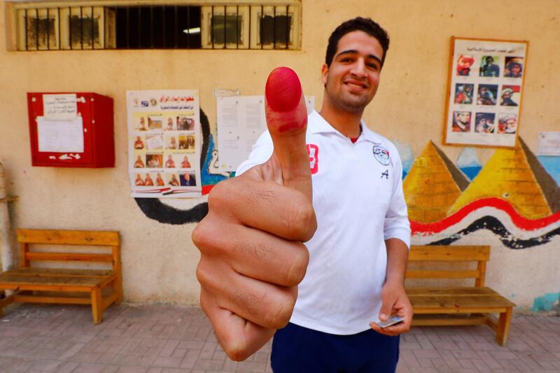 A man shows his ink-stained finger at a polling station in Cairo, Egypt. Reuters