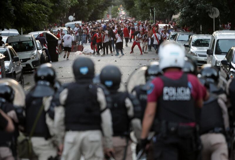River Plate fans clash with riot police after the match was postponed. Reuters