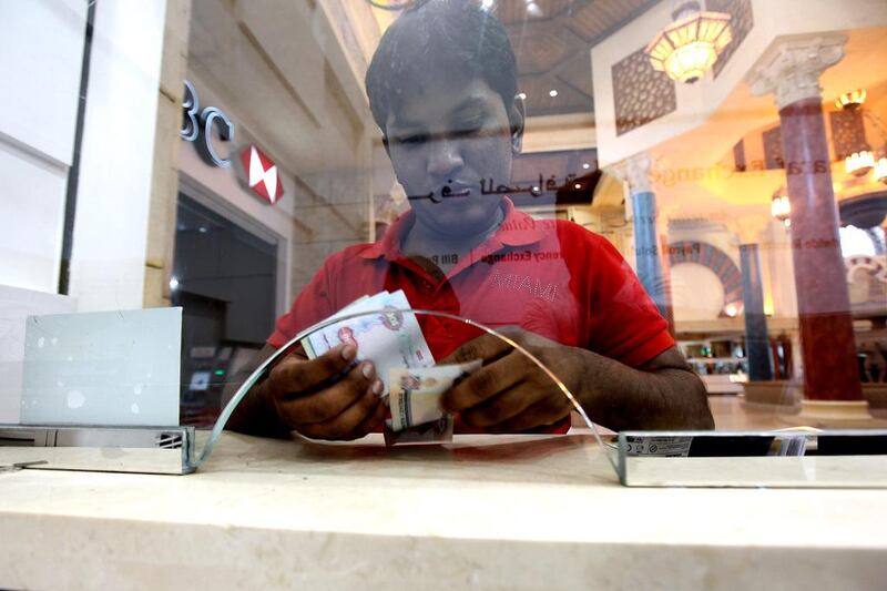 Tahir Mohammed, from Kerala, sends money home from Dubai’s Ibn Battuta Mall. The weak rupee has been a boon to Indians abroad. Pawan Singh / The National