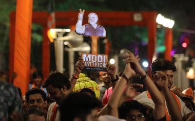 BJP supporters cheer as Indian Prime Minister Narendra Modi speaks at the party's headquarters in New Delhi on Tuesday. EPA