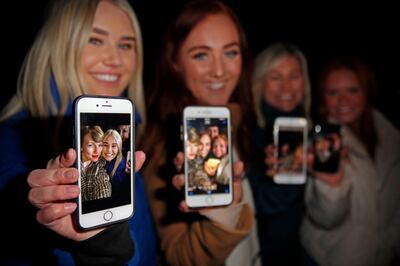 epa08157175 Four family members show off pictures they took with Taylor Swift, after the singer arrived for the premier of her movie, at the premier of her movie 'Miss Americana' during the 2020 Sundance Film Festival in Park City, Utah, USA, 23 January 2020. The festival runs from  the 22 January to 02 February 2020.  EPA/GEORGE FREY