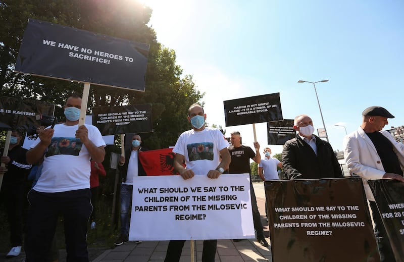 People hold signs as show support for Kosovo's President Hashim Thaci in front of the special tribunal, in The Hague, Netherlands July 13, 2020. REUTERS/ Eva Plevier REFILE - CORRECTING INFORMATION