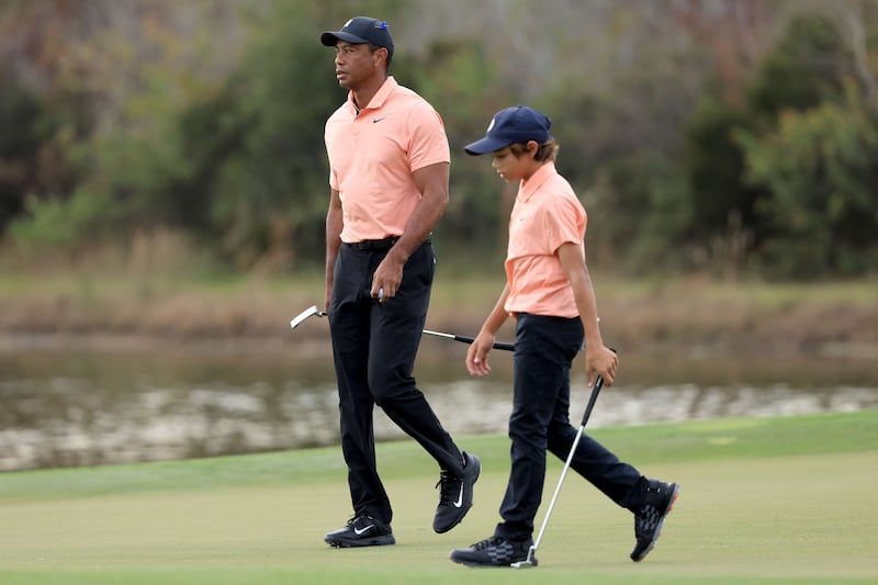 Tiger Woods and Charlie Woods walk off the 14th hole. AFP