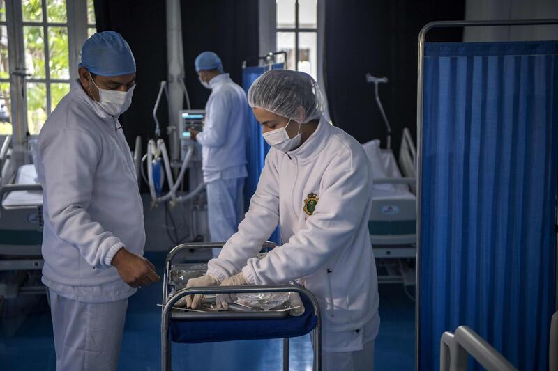 Members of the medical staff at Moroccos's military field hospital in Nouaceur, South of Casablanca, check on equipment on April 18, 2020 as they prepare to receive patients of the coronavirus pandemic. Military hospitals have been reordered to maximise bed capacity, he said, adding that two field hospitals had been deployed to the coastal Casablanca region. Morocco had recorded 2,670 confirmed cases of coronavirus and 137 deaths, while over 280 have officially recovered. The North African kingdom has closed its borders and imposed a lockdown, enforced by security forces, to stem the spread of the disease. 
 / AFP / FADEL SENNA
