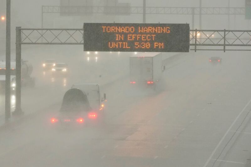 The Mississippi Department of Transport digital message board warns drivers along I-55 southbound in Jackson of a tornado warning during a rainstorm during the outbreak of severe weather in the state on Wednesday, March 30, 2022.  AP
