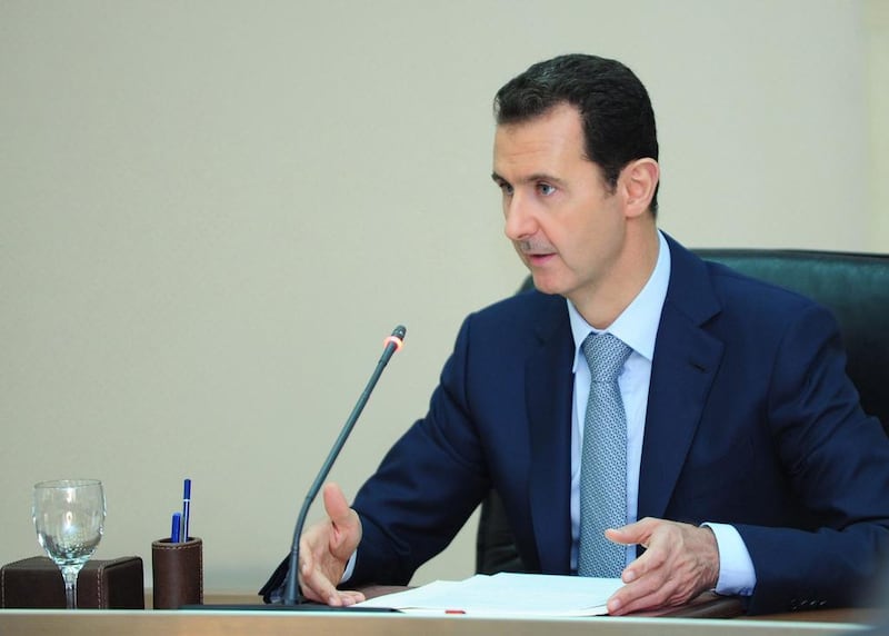 Syrian president Bashar Al Assad meets with the ministers of the newly-formed government after the oath-taking ceremony in Damascus in 2014. SANA / EPA