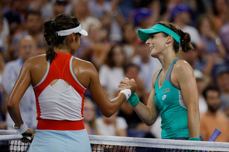 Alize Cornet, right, shakes hands with Emma Raducanu after their match. Reuters