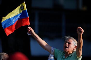 A supporter of opposition leader and self-proclaimed interim president Juan Guaido, holding a Venezuelan flag, cheer him on during a rally in a west side neighbourhood in Caracas, Venezuela, Friday, April 5, 2019. AP