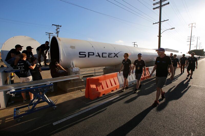 Members of the WARR team from Technische Universitat Munchen walk to the end of the SpaceX's Hyperloop track to retrieve their winning pod in Hawthorne, California,. The WARR team from the university won the competition with a peak speed of 324 kilometers per hour (201 mph). Damian Dovarganes / AP Photo