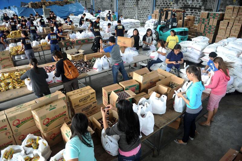 Volunteers repacking relief goods at the Department of Social Welfare and Development(DSWD) in Manila 

. AFP PHOTO / Jay Directo

