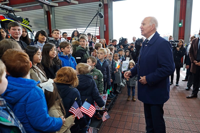 Mr Biden is greeted by family and friends of US embassy staff at the fire station at Dublin Airport. EPA