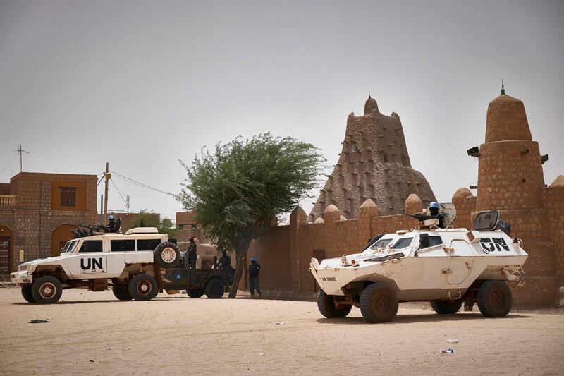 United Nations vehicles patrol in front of the mosque Sankore in Tombouctou on March 31, 2021. A symbolic euro was handed over to the government of Mali and UNESCO for damage inflicted by Islamists who wrecked Timbuktu's World Heritage-listed mausoleums in 2012. Fatou Bensouda, the ICC's chief prosecutor, said the case represented the international community's commitment to "defend the foundation of our common identity." / AFP / MICHELE CATTANI
